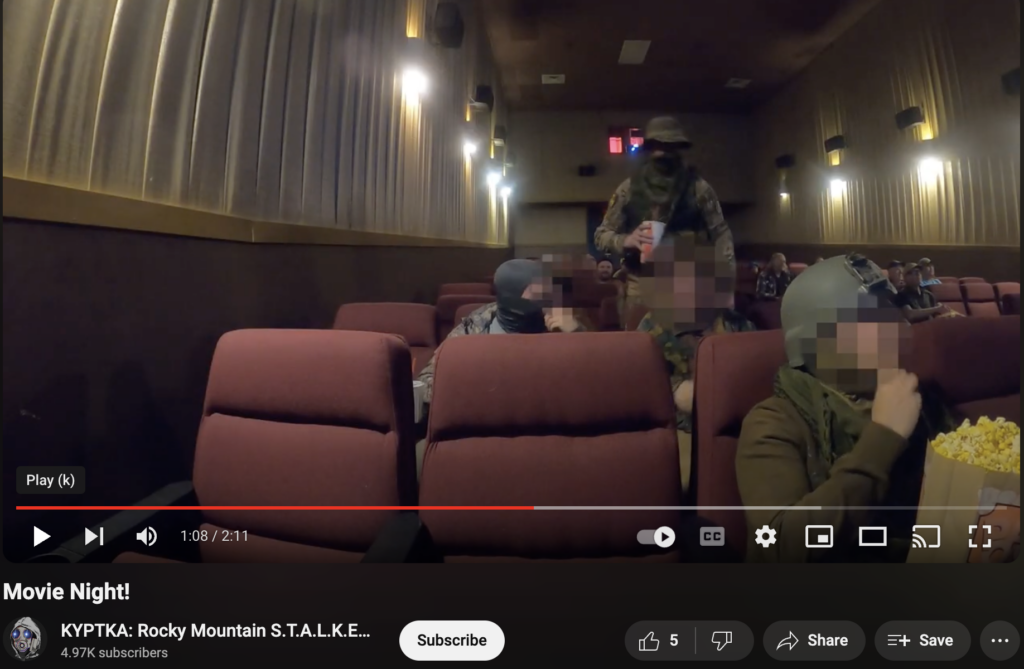 Trenin Bayless and others at the movie theater dressed in military gear. they make Trenin's wife sit in a row by herself